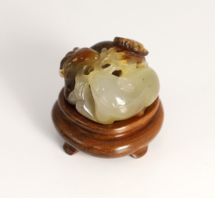 A Chinese two colour agate carving of a ram and a cat, 19th century, 4cm, wood stand